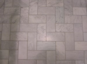 The bathroom floor is marble subway tile installed in a straight herringbone. Just enough interest without making the small footprint too busy.